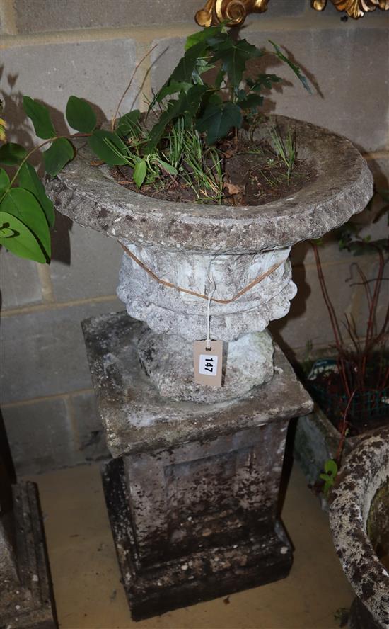 A reconstituted stone urn on plinth, height approx. 81cm, width approx. 41cm